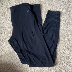 Black athletic leggings with mesh detail on back